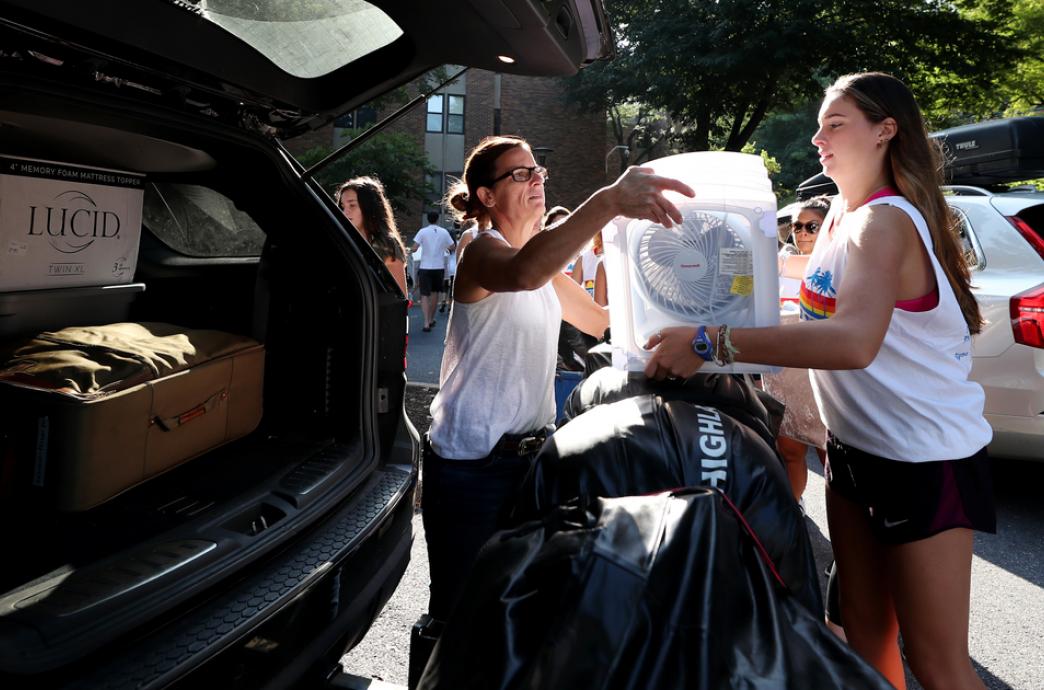 Mom and daughter unloading back of van during Lehigh move in day.