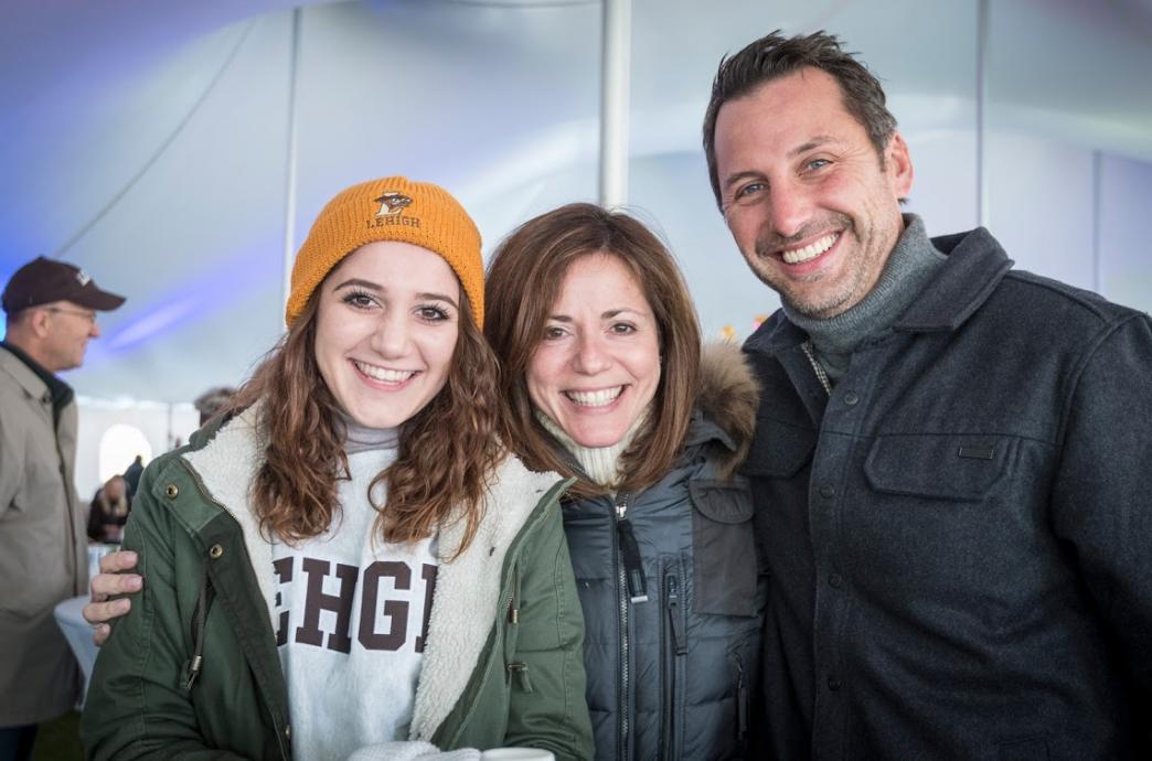 A student and her parents in the tent for Family weekend