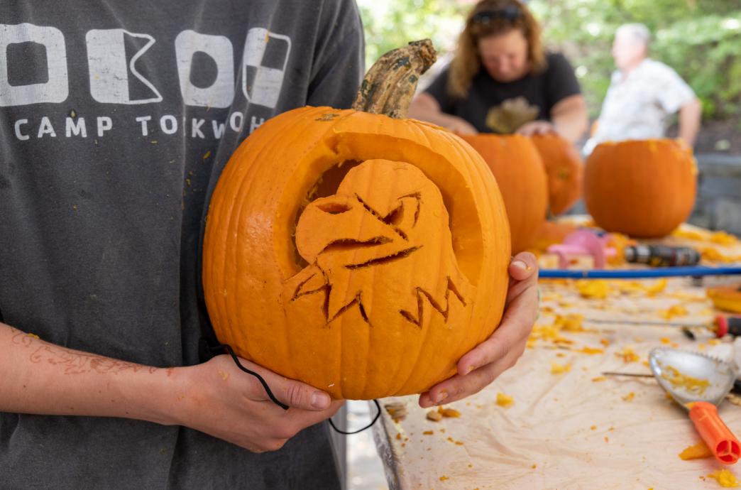 Student holding a Mountain Hawk Pumpkin Carving