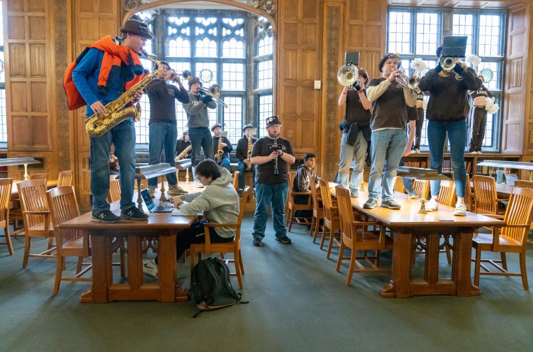 Marching 97 band members on tables in Linderman Library