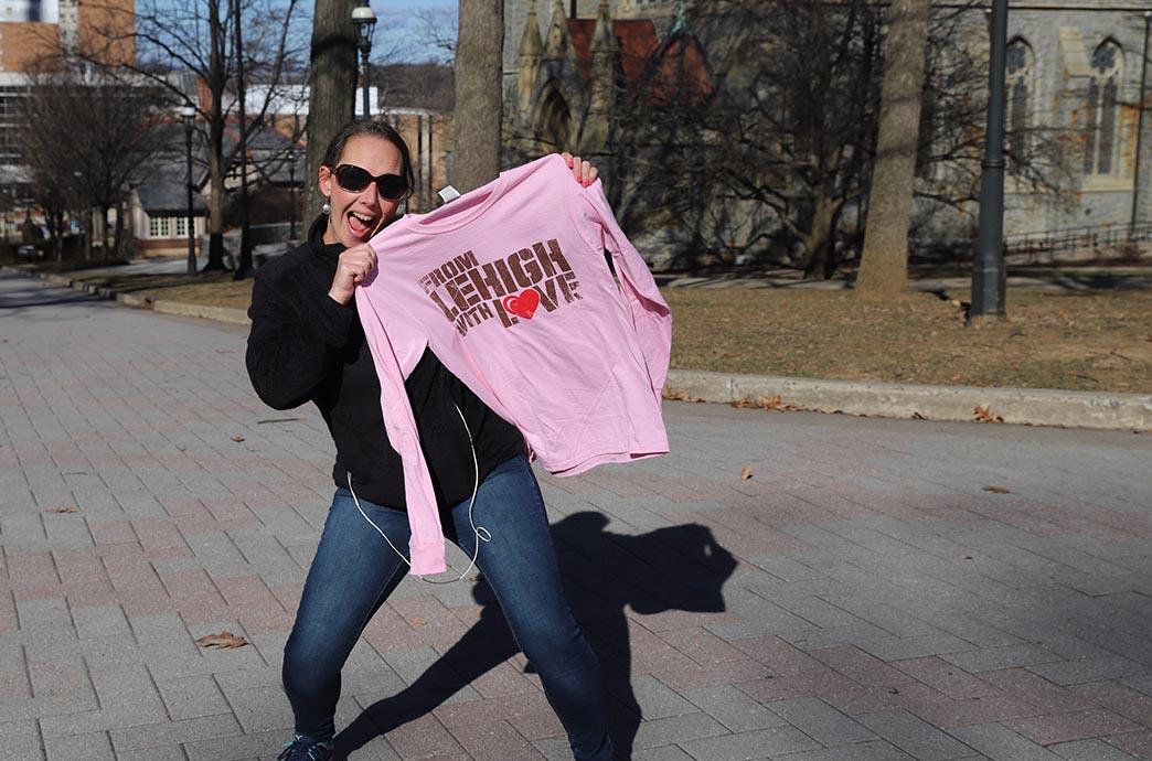 Staff member holds shirt at fun angle