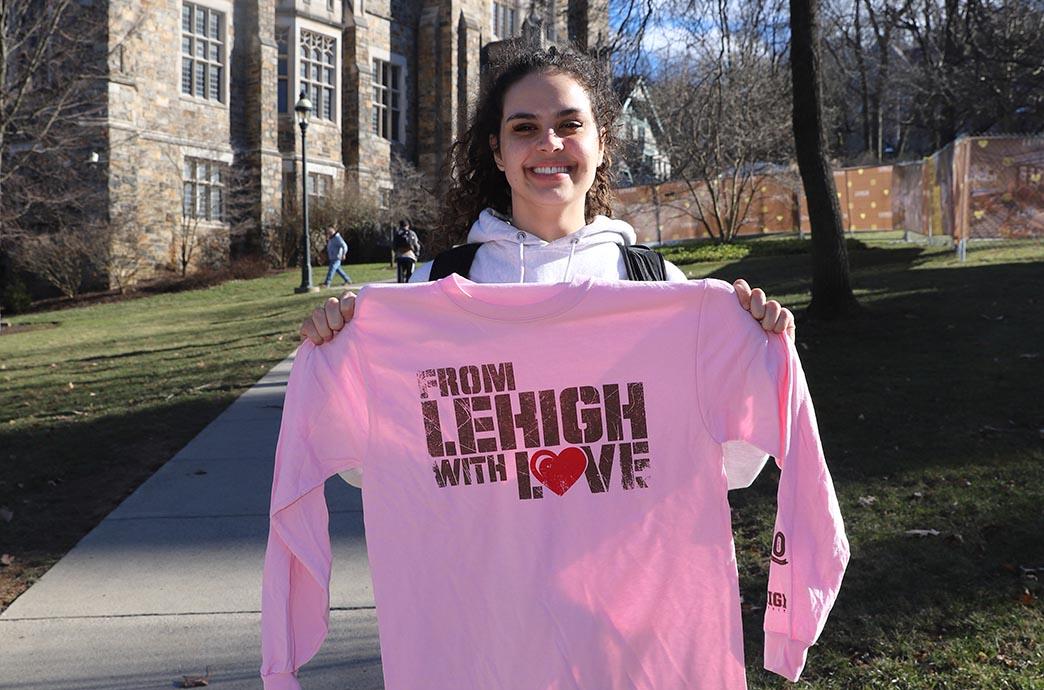 Student holds shirt up