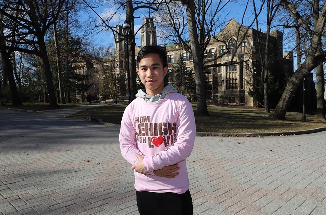 Student crosses his arms with shirt on