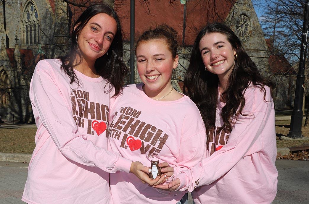 Three students wear the shirts