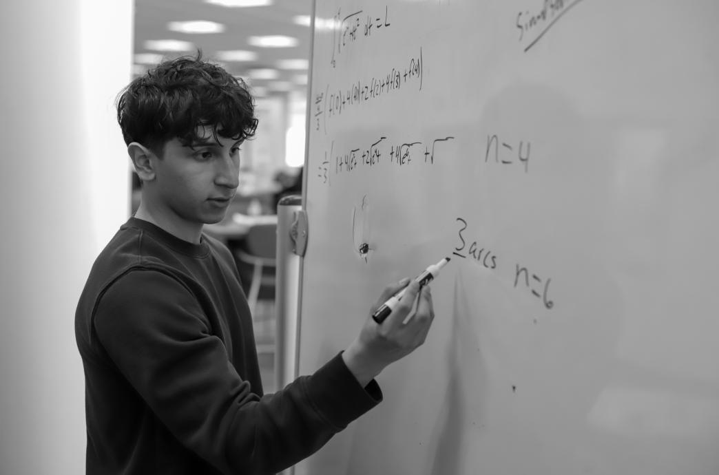 A student using a whiteboard in FML
