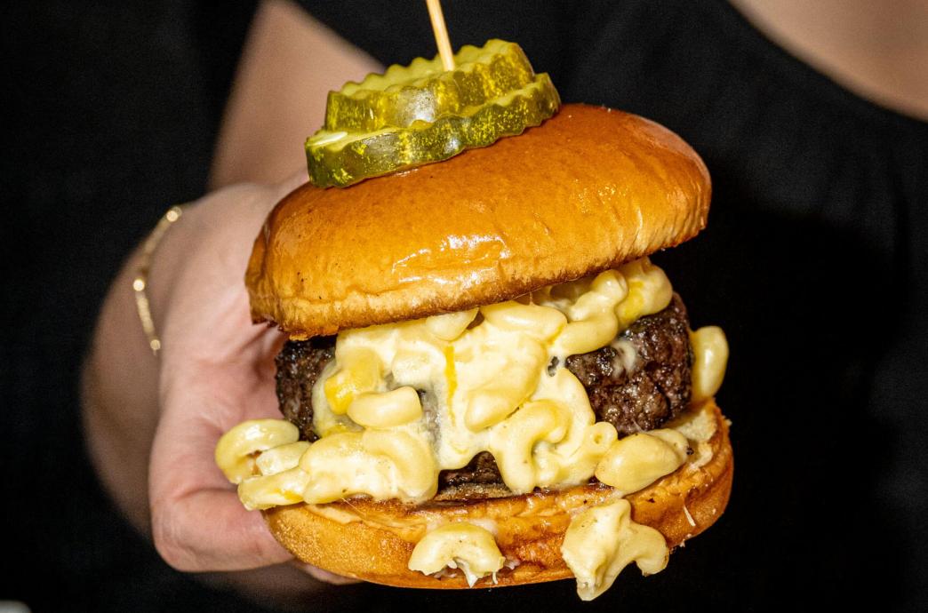 A burger swimming in mac and cheese