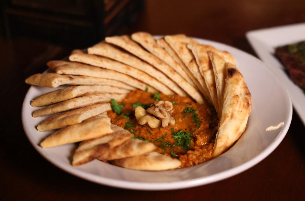 Moroccan Red Pepper Dip surrounded by slices of flat bread