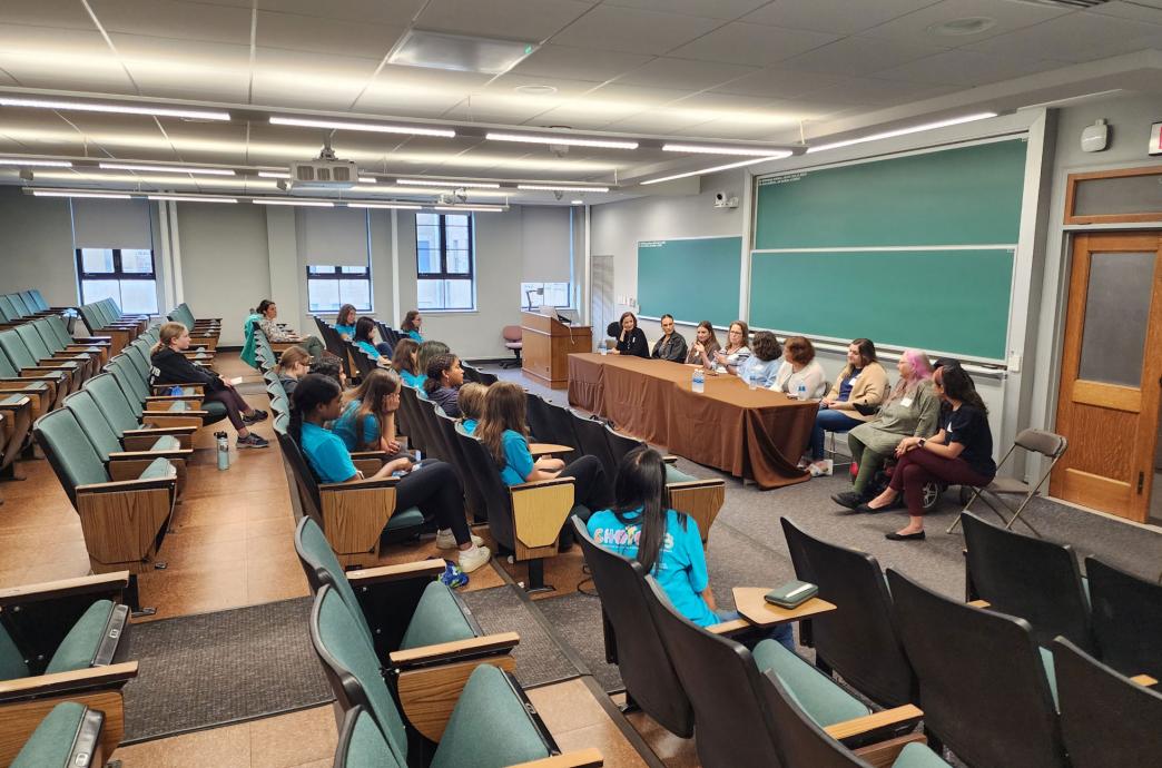 Young women asking a panel of alumnae questions about the program