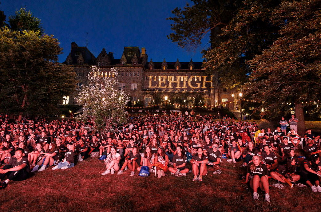 A large crowd of Lehigh students sit on the University Center lawn