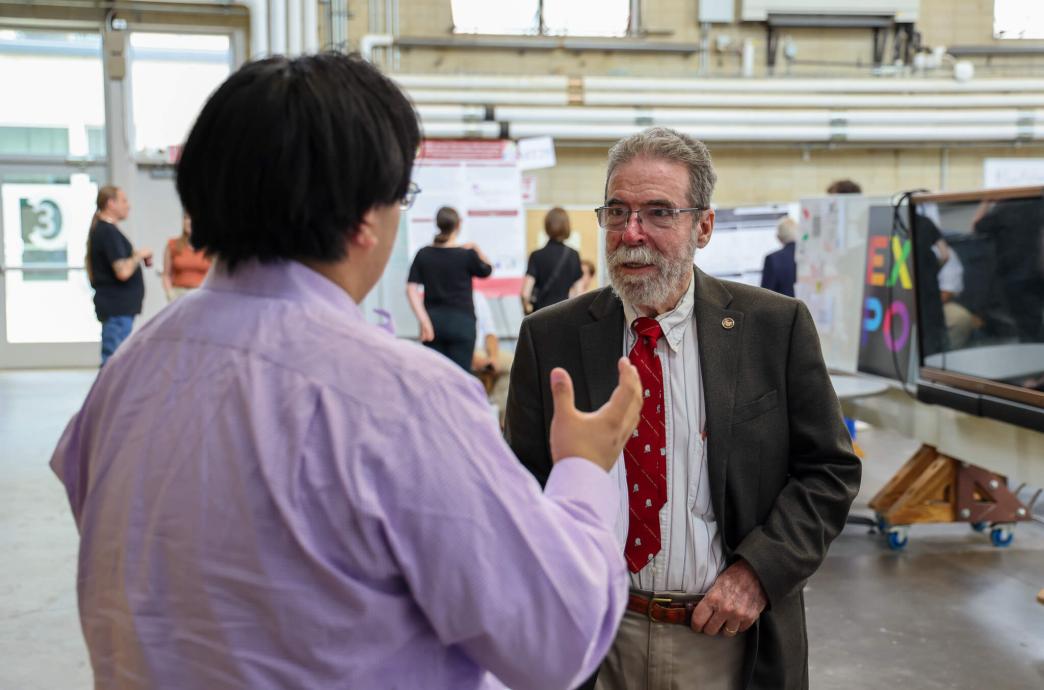 Judge Jose Arencibia discussing a project with another individual