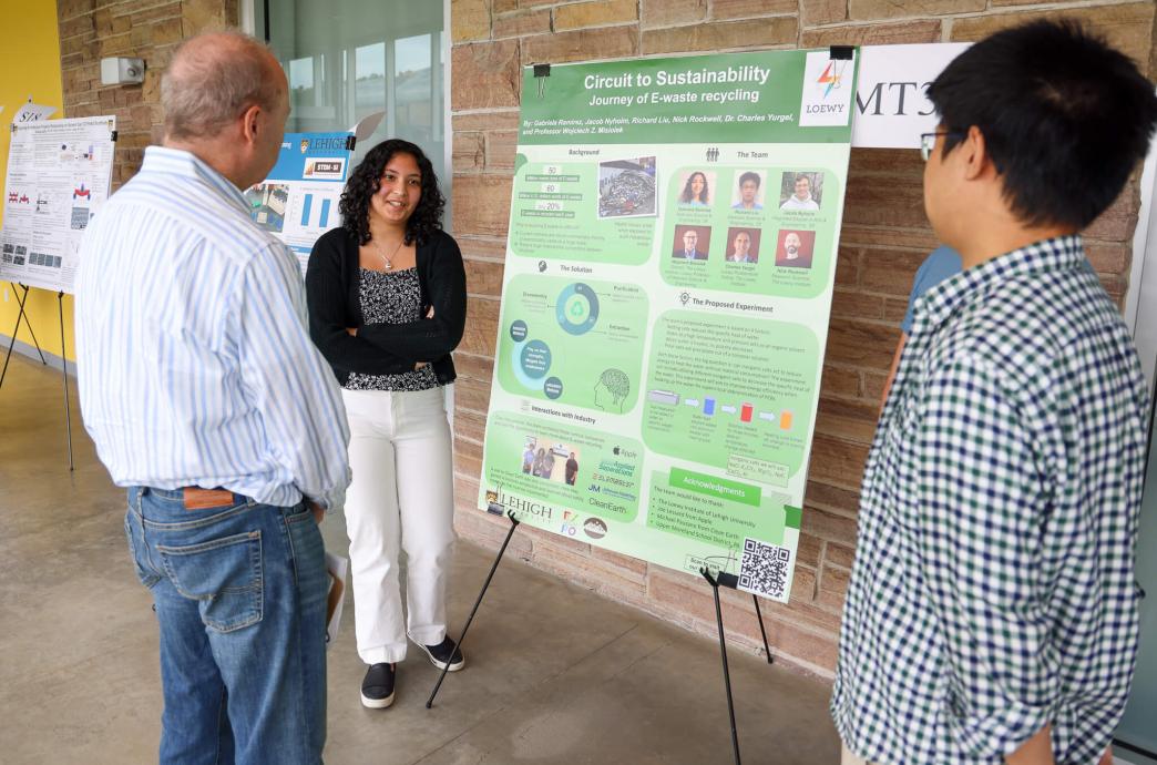 Gabriela Ramirez positioned by her poster talking about her project