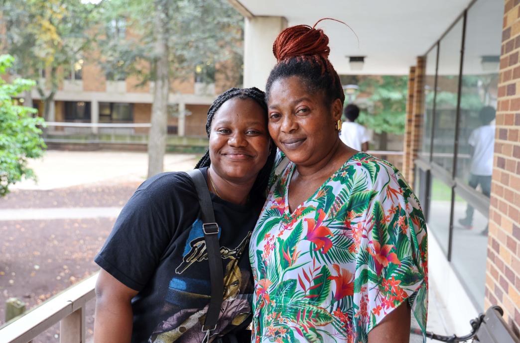 A student and her mother hugging and smiling