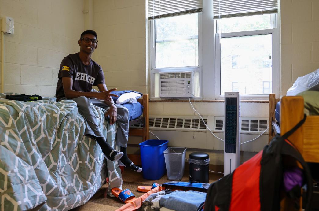 A student sitting on his bed