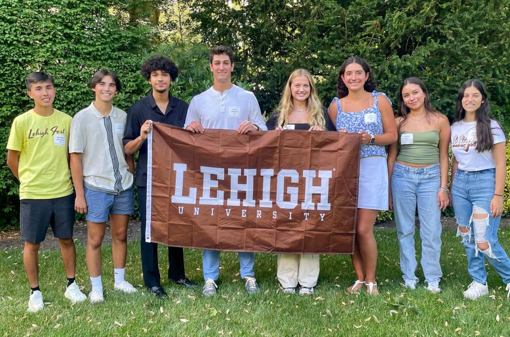 Incoming students posing with a brown Lehigh University flag