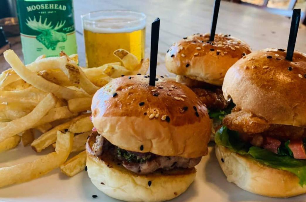 Beef sliders on seeded buns served with Fries