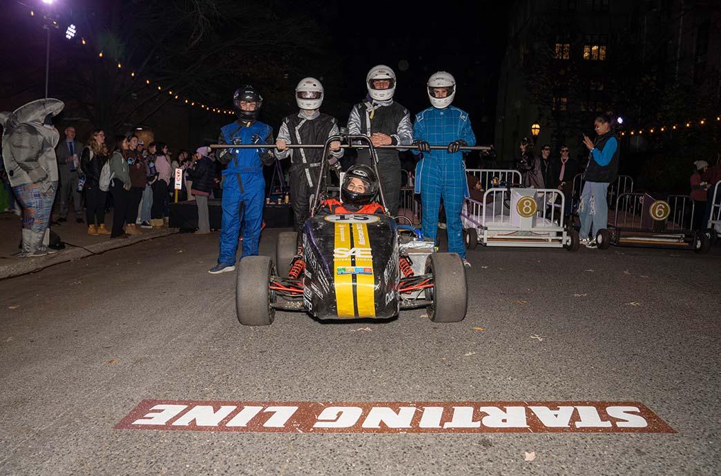 Lehigh Racing Team students stand at the starting line of Bed Races on Packer Avenue with a race car they built.