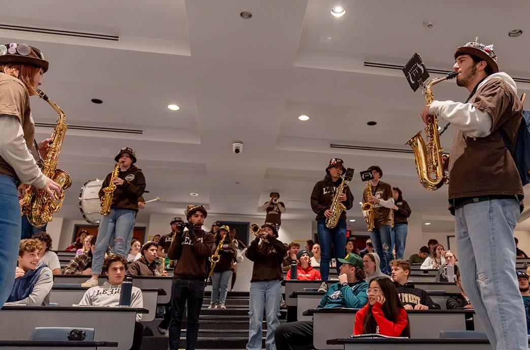 Lehigh University's marching band performs during a lecture as students watch.
