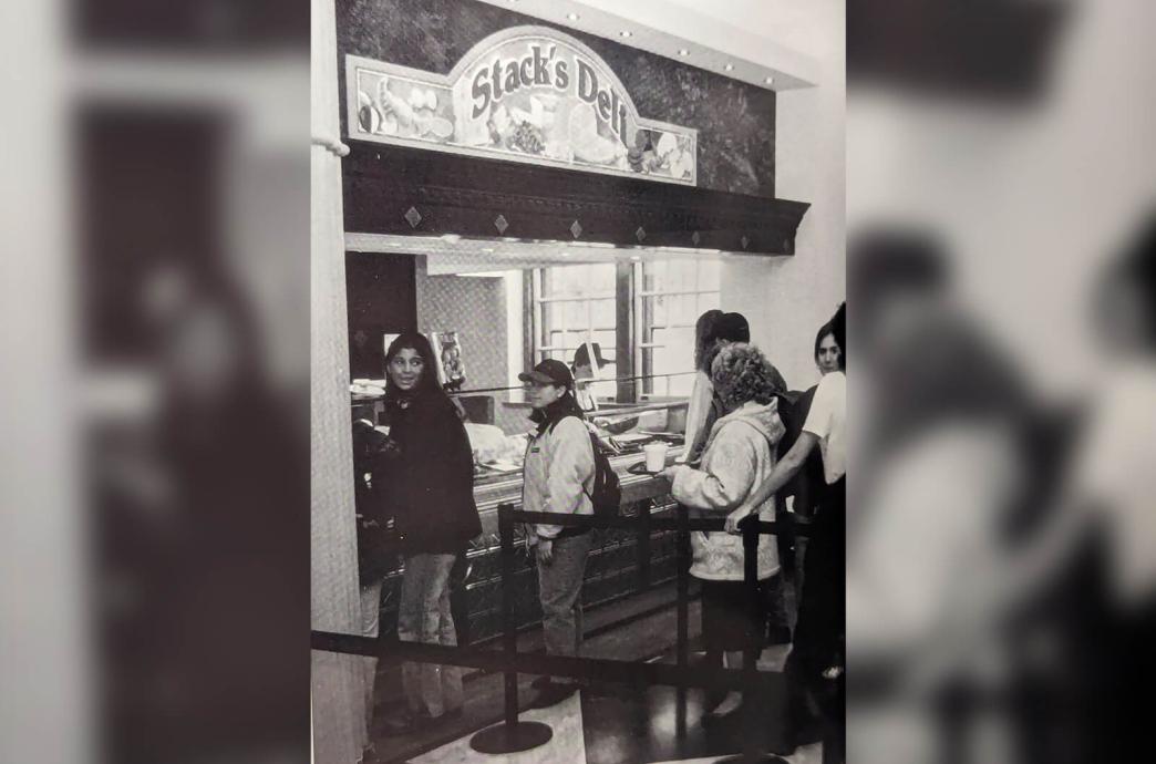 Black and white photo from the 1996 yearbook shows students lined up at the Stack's Deli counter.