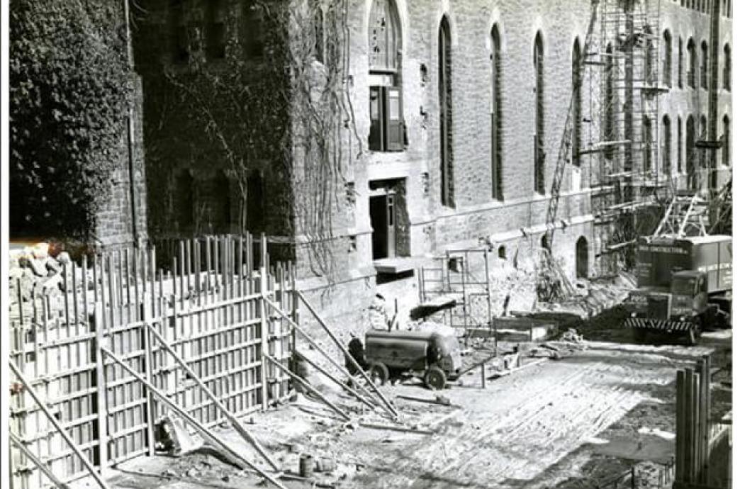 A 1955 black and white photo of the exterior of the UC shows demolition on the ground floor with supplies and equipment.