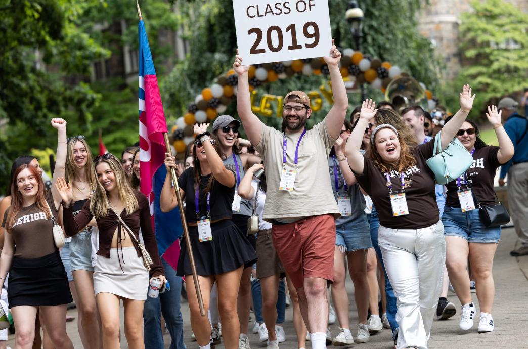 Class of 2019 parades at reunion holding a sign with their class year