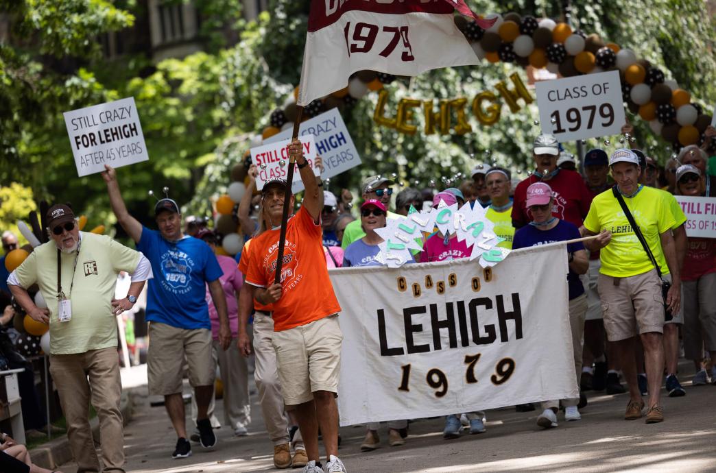 Class of 1979 holds flags, signs, and banners at Reunion parade, some saying "Still Crazy For Lehigh"