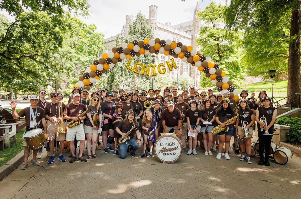 The Lehigh Alumni Band poses with the instruments and family under a balloon arch at Reunion.