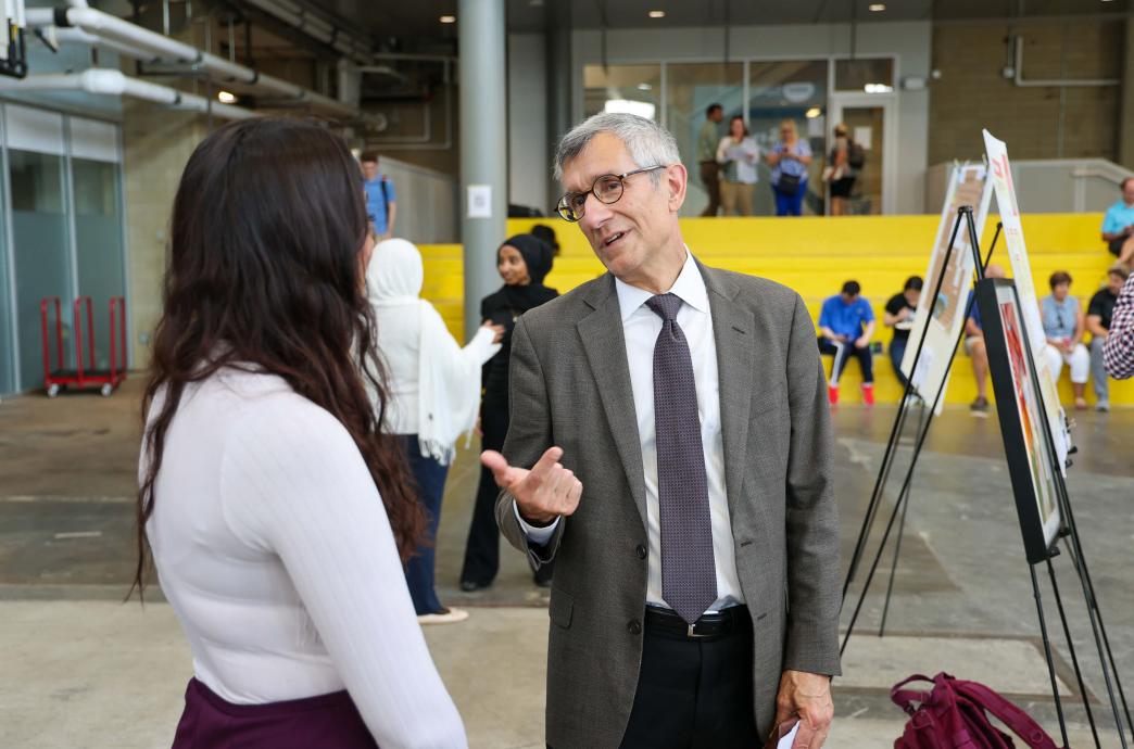 President Joseph J. Helble engages with student researchers