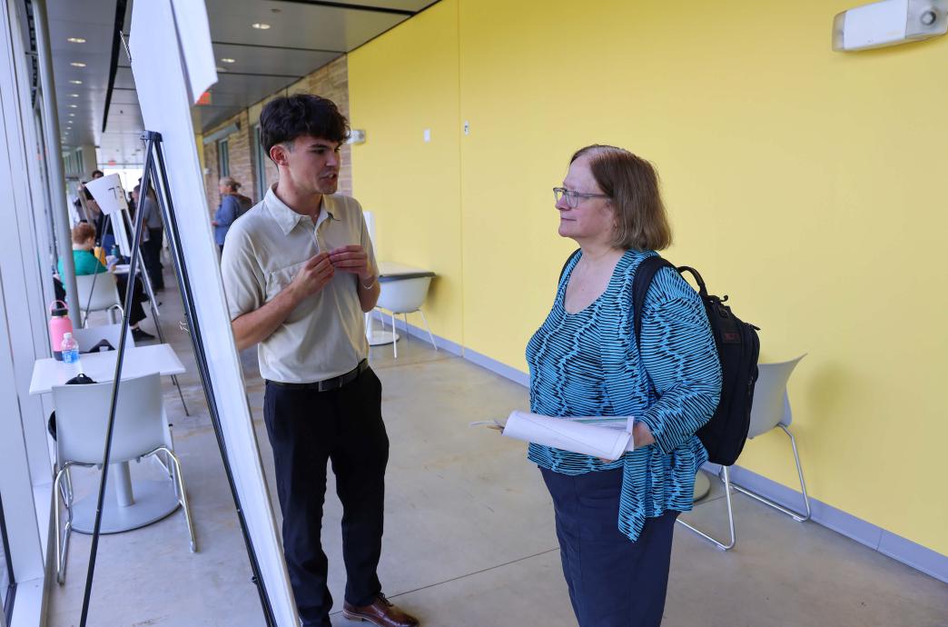 Dr. Julia Klees ’82 stops to speak with each presenter at the 2024 Research Expo.