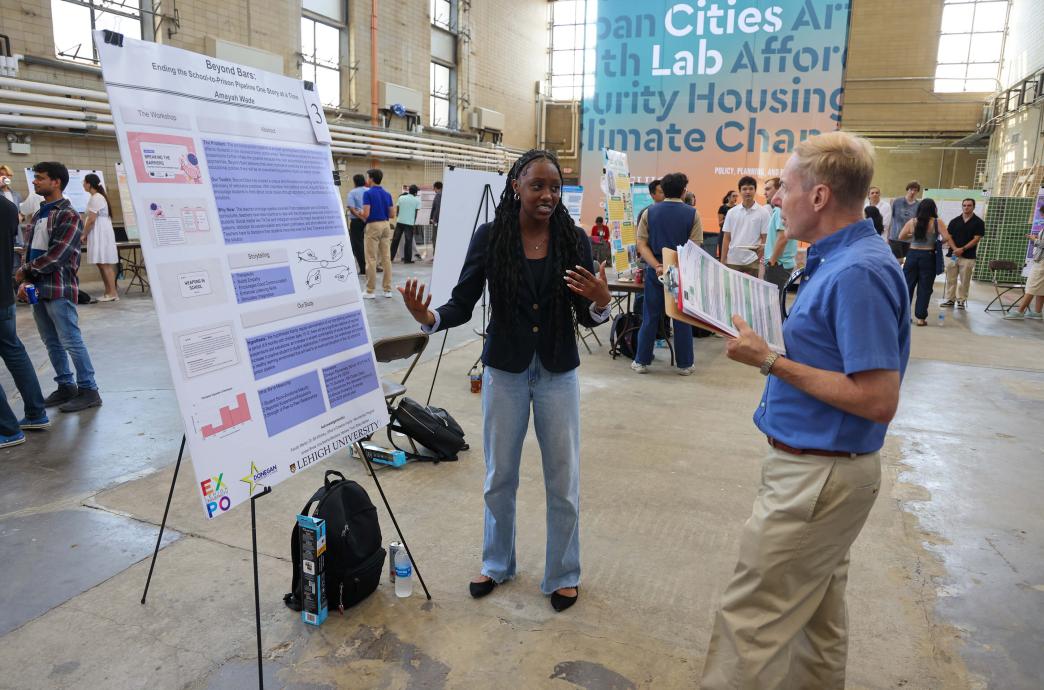Expo judge Mark Shiner ’77 visits the presentation for “Beyond Bars” with Amayah Wade.