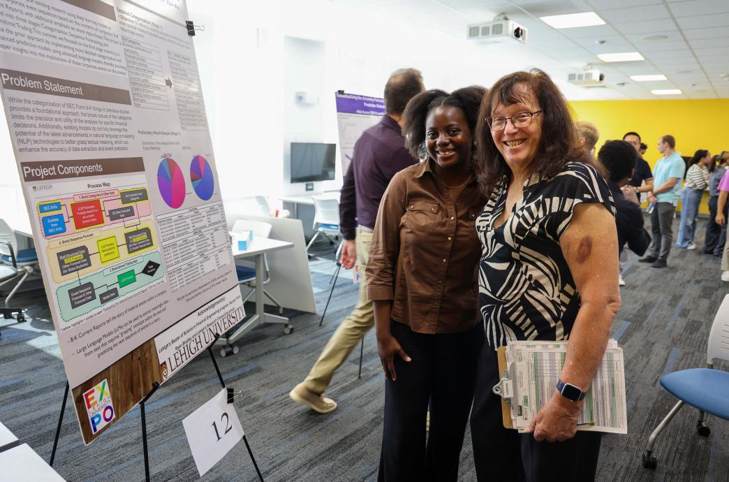 Expo judge Tama M. Copeman ’81G ’86G smiles while engaging with students at the 2024 Summer Expo.