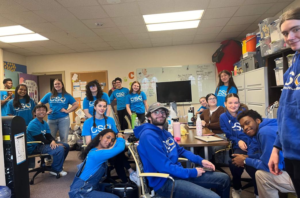 A room of students wearing matching blue tshirts in a classroom.