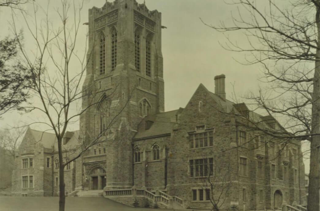 A historic photo of a stone building with a tower showcasing classic architecture.
