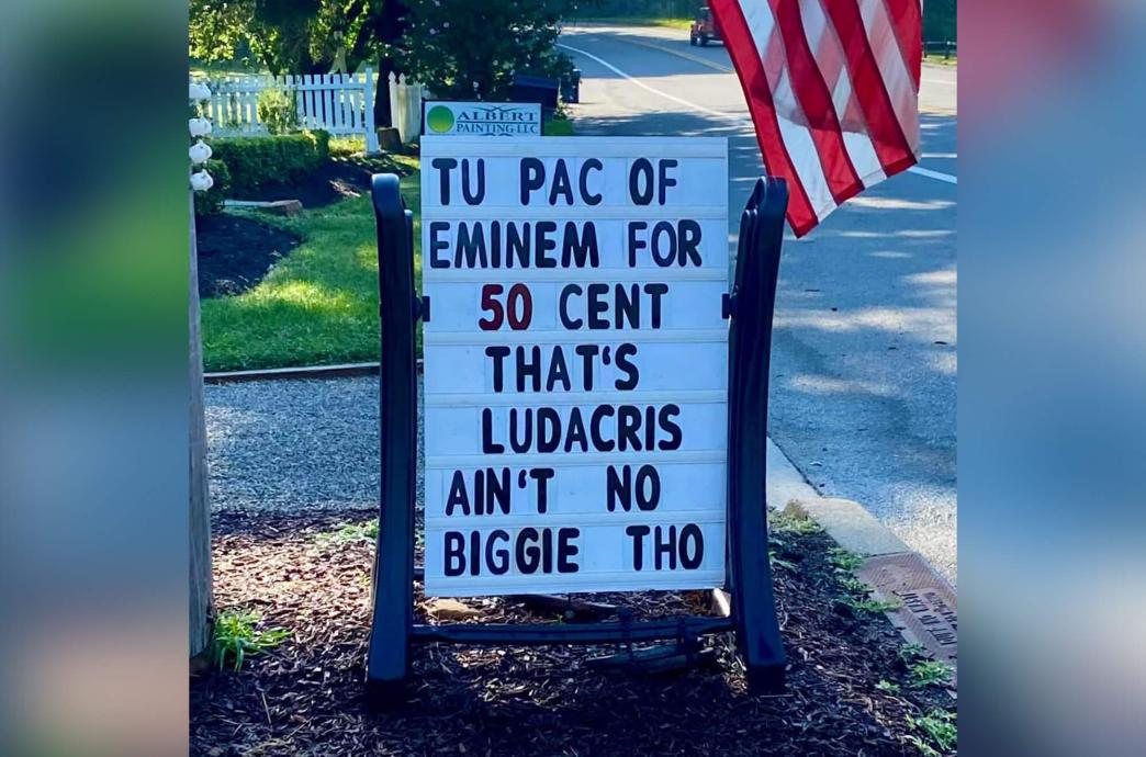 A letterboard on a roadside reads “Tu Pac of Eminem for 50 Cent. That’s Ludacris. Ain’t No Biggie tho.”