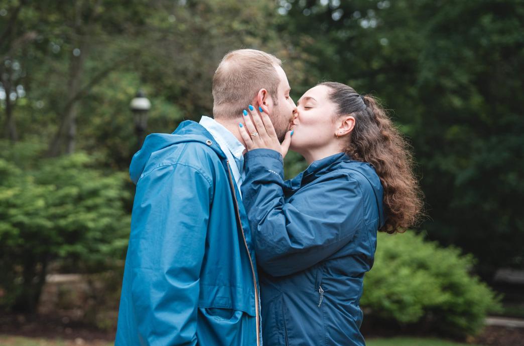 Anderson kisses Hillegas after their proposal at Reunion, holding his face with both hands.