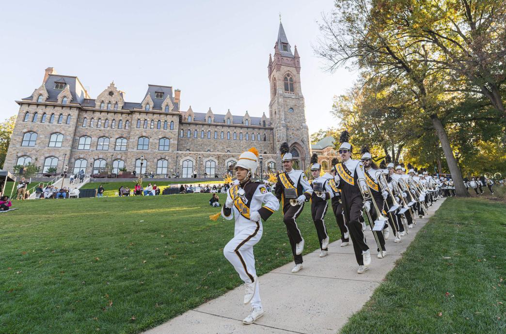 On the walkway running along the front lawn of the Clayton UC, the Marching 97  parades in their full regalia.