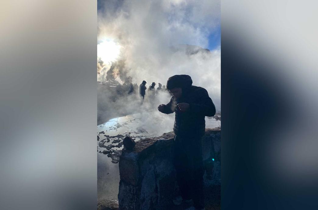 Michael stands in the El Tatio geothermal field in the Atacama Desert. Cold mist is visible everywhere.