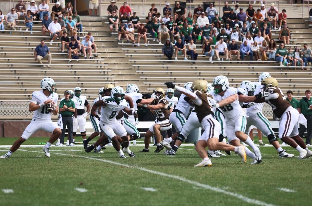 Action shot of Lehigh's football team squaring off against Dartmouth. The teams are running mid-play.