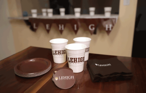 Lehigh Party Pack consisting of Lehigh-themed coasters, cups, napkins, and brown plates.