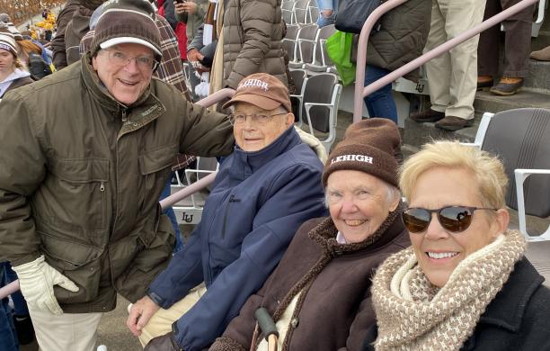 Joe Workman ’53 sitting with his family in the stands at Goodman Stadium