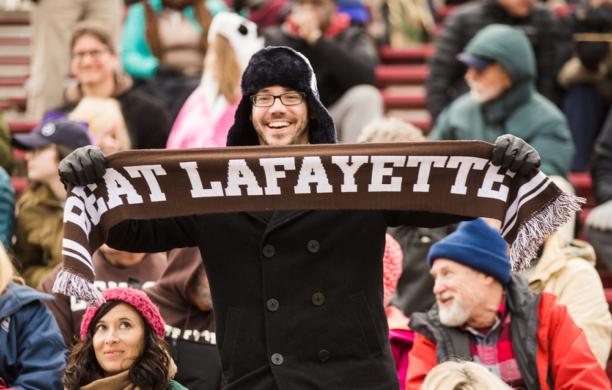 Fan in the crowd holding a Beat Lafayette scarf