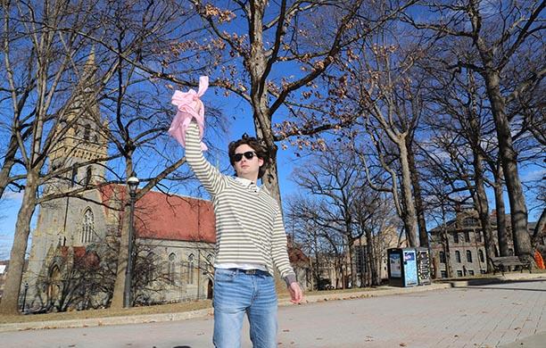 Student catches a pink tee shirt