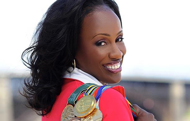 Jackie Joyner-Kersee holds her Olympic medals over her shoulder