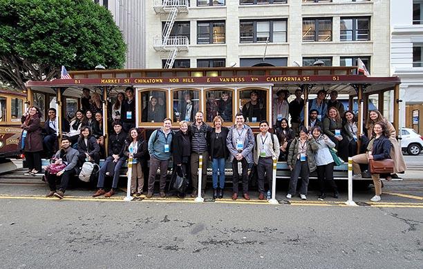 LSV participants and leaders stand in front of a San Francisco trolley