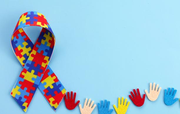Autism Awareness Ribbon with colorful children's handprint cutouts