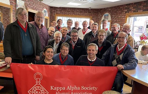 The Kappa Alpha Society poses inside Petes Hot Dog Shop
