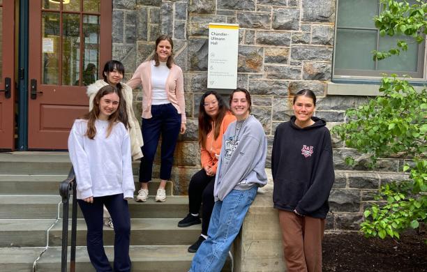 Peer relations lab researchers smiling in front of stone stairs