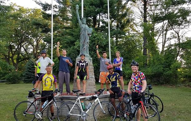 Gary Pan with a crew of scouts that biked across the US stand in front of Statue of Liberty replica