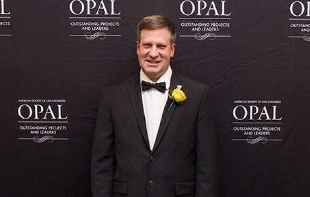 Kuklinski stands in a black tuxedo at an awards ceremony
