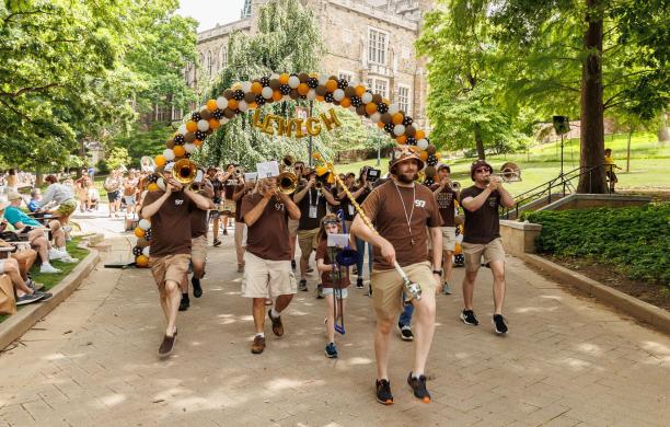 The Alumni band walking under the Lehigh balloon arch during the parade of classes