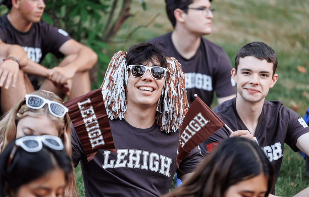 Lehigh students show off their brown and white with t shirts, flags, pom poms, sunglasses.